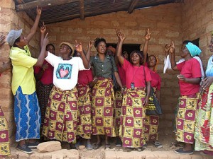 The women celebrate each new roof with song and dance